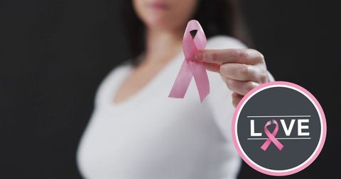 Breast Cancer Awareness: Woman Holding Pink Ribbon Symbol