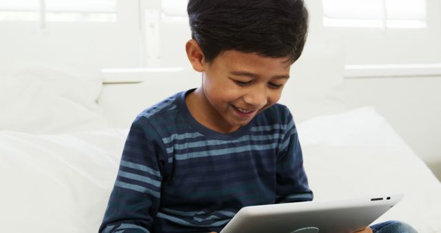 Smiling Child Using Tablet at Home - Download Free Stock Images Pikwizard.com