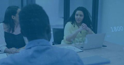 Businesswoman Leading Meeting with Team at Conference Table
