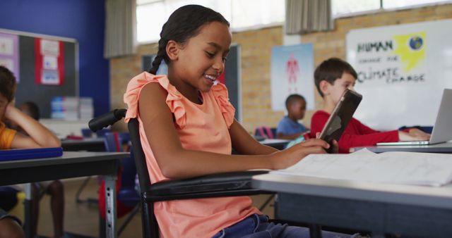 Smiling girl is using a tablet in a classroom. Setting includes other students engaged in learning activities in the background. Classroom has colorful posters and educational materials. Represents technology in education, inclusivity, and modern teaching methods. Useful for educational materials, advertisements for school supplies or technology, and articles on inclusive education.