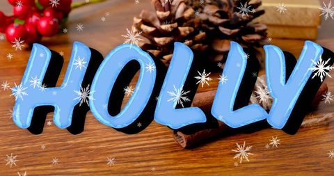 this digital creation features the word 'holly' in bold, blue typography with snowflakes gently falling. it rests alongside christmas decorations such as pine cones, cinnamon sticks, and red berries on a wooden surface, evoking a cozy winter setting. the festive theme and color palette makes it ideal for holiday greeting cards, social media banners, or seasonal digital advertising.
