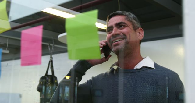 Smiling Entrepreneur Using Smartphone in Office - Download Free Stock Images Pikwizard.com