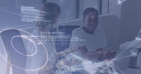 Collaborating women debugging code with network graphics overlay