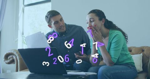 Surprised couple analyzing financial data on laptop