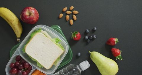 Healthy packed lunch with fruits and sandwich