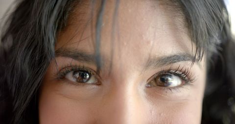 Joyful Biracial Teen With Long Hair at Home