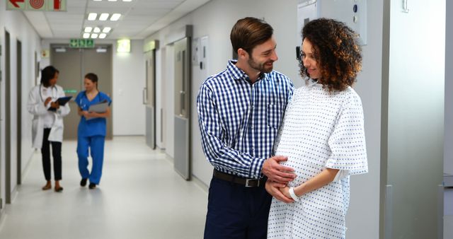 Expectant Couple Smiling in Hospital Hallway - Download Free Stock Images Pikwizard.com