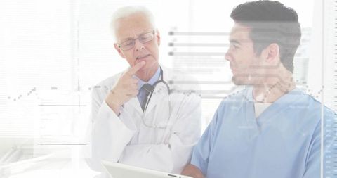 Senior Doctor Mentoring Junior Physician Reviewing Clinical Data on Tablet with Graphs
