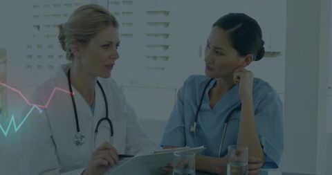 Doctor and Nurse Collaborating Discuss Patient Case in Modern Clinic