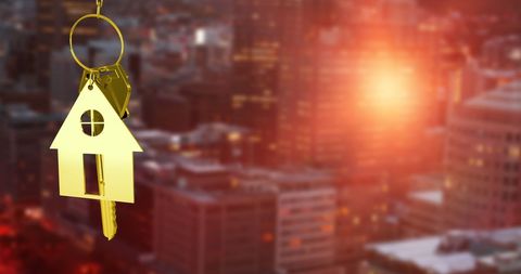 Golden House Key Over Blurred Cityscape Background