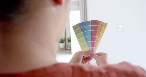 Woman examining color swatches for interior design choice