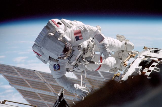 STS104-315-005 (12-24 July 2001) --- With Earth's horizon in the background, astronaut Michael L. Gernhardt, STS-104 mission specialist, participates in one of three space walks aimed toward wrapping up the completion of work on the second phase of the International Space Station (ISS).  Gernhardt was joined on the extravehicular activity (EVA) by astronaut James F. Reilly.
