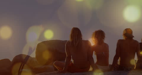 Silhouetted Friends Enjoying Sunset at Beach