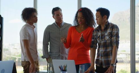 Diverse Team Collaborating on Office Project with Technology Interface