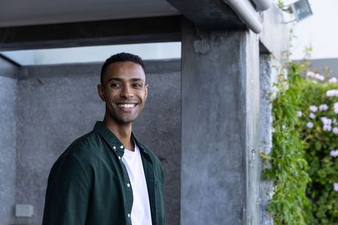 African american man smiling in urban outdoor patio