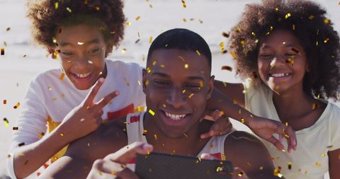 Joyful Family Celebrating Christmas with Beach Selfie