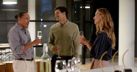 Colleagues socializing over drinks in casual office setting