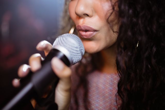 Close up of female singer singing at nightclub during music festival