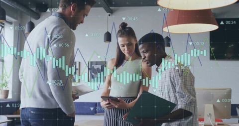 Diverse team analyzing data with digital tools in modern office