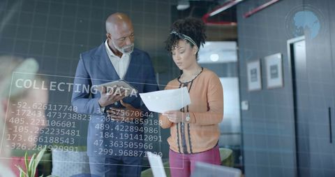 Diversified Team Analyzing Financial Data in Modern Office