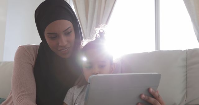 Smiling Mother and Daughter Using Digital Tablet Together at Home - Download Free Stock Images Pikwizard.com