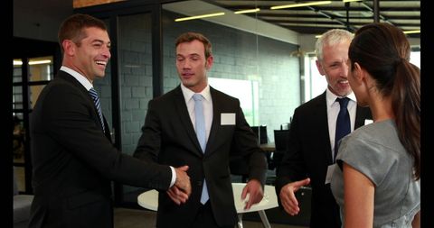 Professional Businessmen Shaking Hands in Modern Office Space