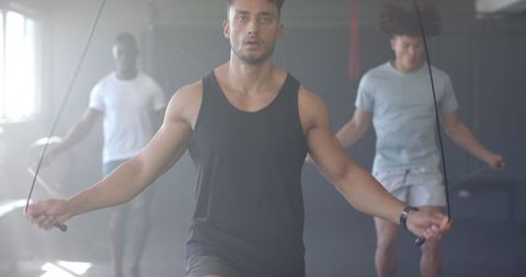 Men jumping rope in gym for cardio workout
