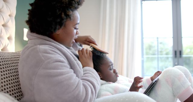 Mother Braiding Daughter's Hair While Relaxing at Home - Download Free Stock Images Pikwizard.com