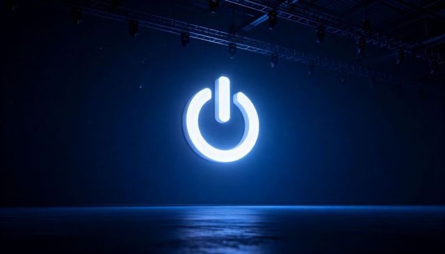 Glowing power-on symbol hovering over dark stage casting blue halo and industrial rigging
