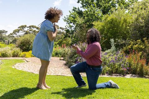 Marriage proposal in lush garden setting