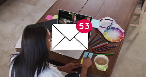 Multitasking Woman on Video Call Receiving Numerous Emails