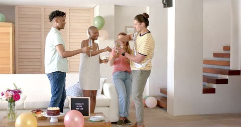 Friends Celebrating New Job with Champagne at Home Gathering