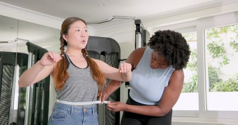 Trainer measuring coaching success with enthusiastic client