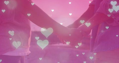 Romantic Couple Holding Hands at Sunset with Heart Overlay