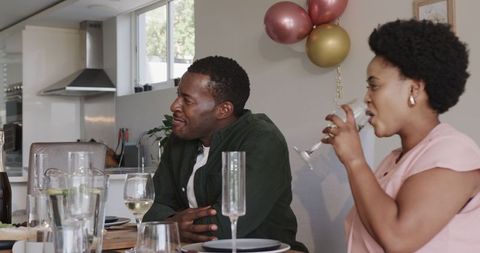 Group of Friends Enjoying Wine and Laughter at Home