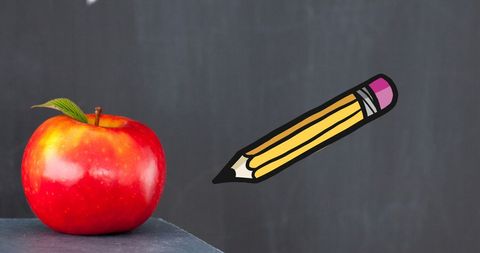 Colorful Pencils and Apple on Blackboard Background