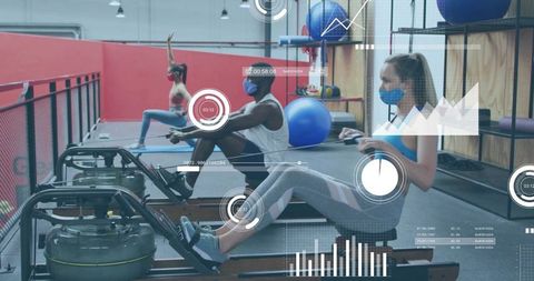 Indoor rowing class wearing face masks with digital hud tracking fitness performance