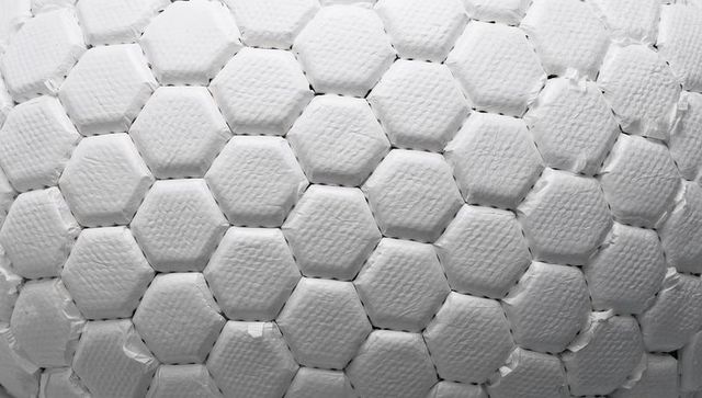 White hexagonal foam honeycomb pattern showing seams and textured surface