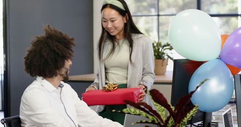 Employee receiving gift during work office celebration