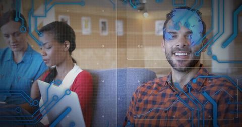 Smiling professional using laptop in modern coworking lounge with digital circuitry overlay