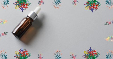 Brown Cosmetic Dropper Bottle Surrounded by Floral Elements