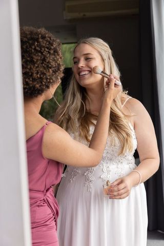 Bride getting bridal makeup done by professional makeup artist