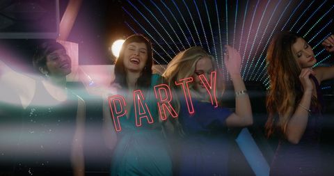 Young Women Joyfully Dancing under Colorful Lights at Nightclub