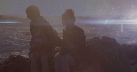 Silhouetted Family Reflecting by Tranquil Seaside