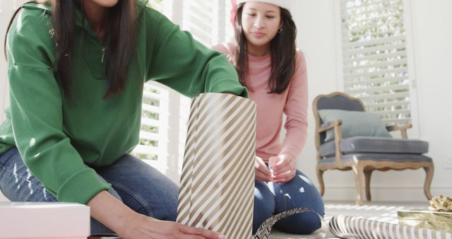 Mother and Daughter Wrapping Christmas Gifts at Home - Download Free Stock Images Pikwizard.com