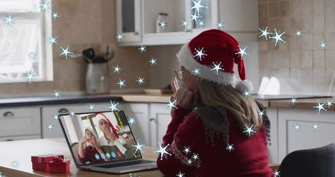 Woman in Santa Hat on Video Call with Snow Effects Celebrating Christmas