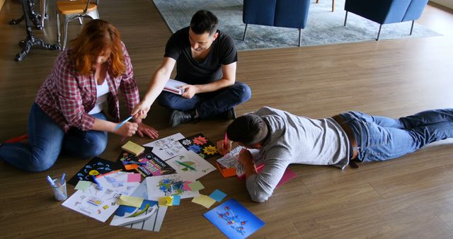 Creative Team Brainstorming Ideas with Coloring Sheets on Floor - Download Free Stock Images Pikwizard.com