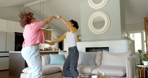 Diverse Female Friends Joyful Dance in Modern Living Space