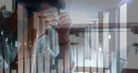 Worried Man Analyzing Financial Data on Laptop