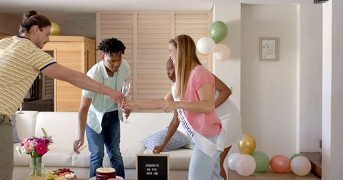 Friends Celebrating New Job at Home with Champagne Toast